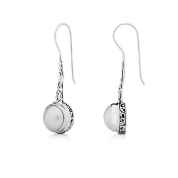 Silver earrings dominate the jewellery
